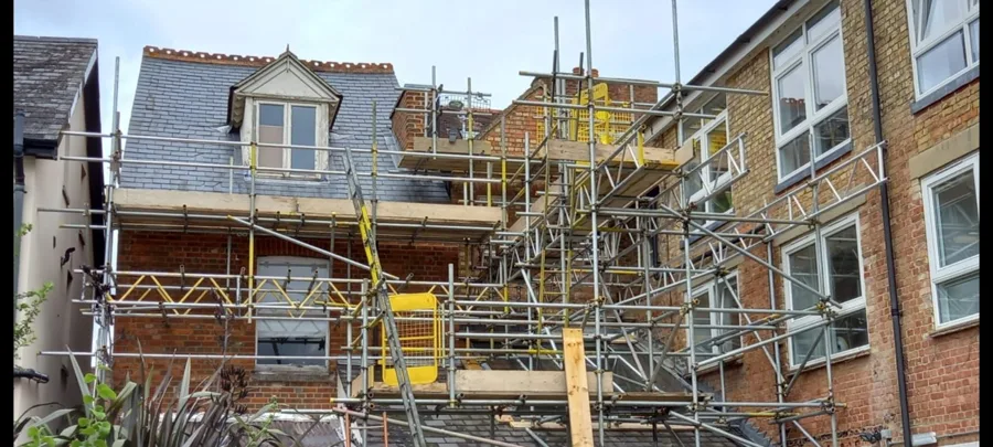 Multi-lift scaffold access built up the rear of a period brick property in Oxford